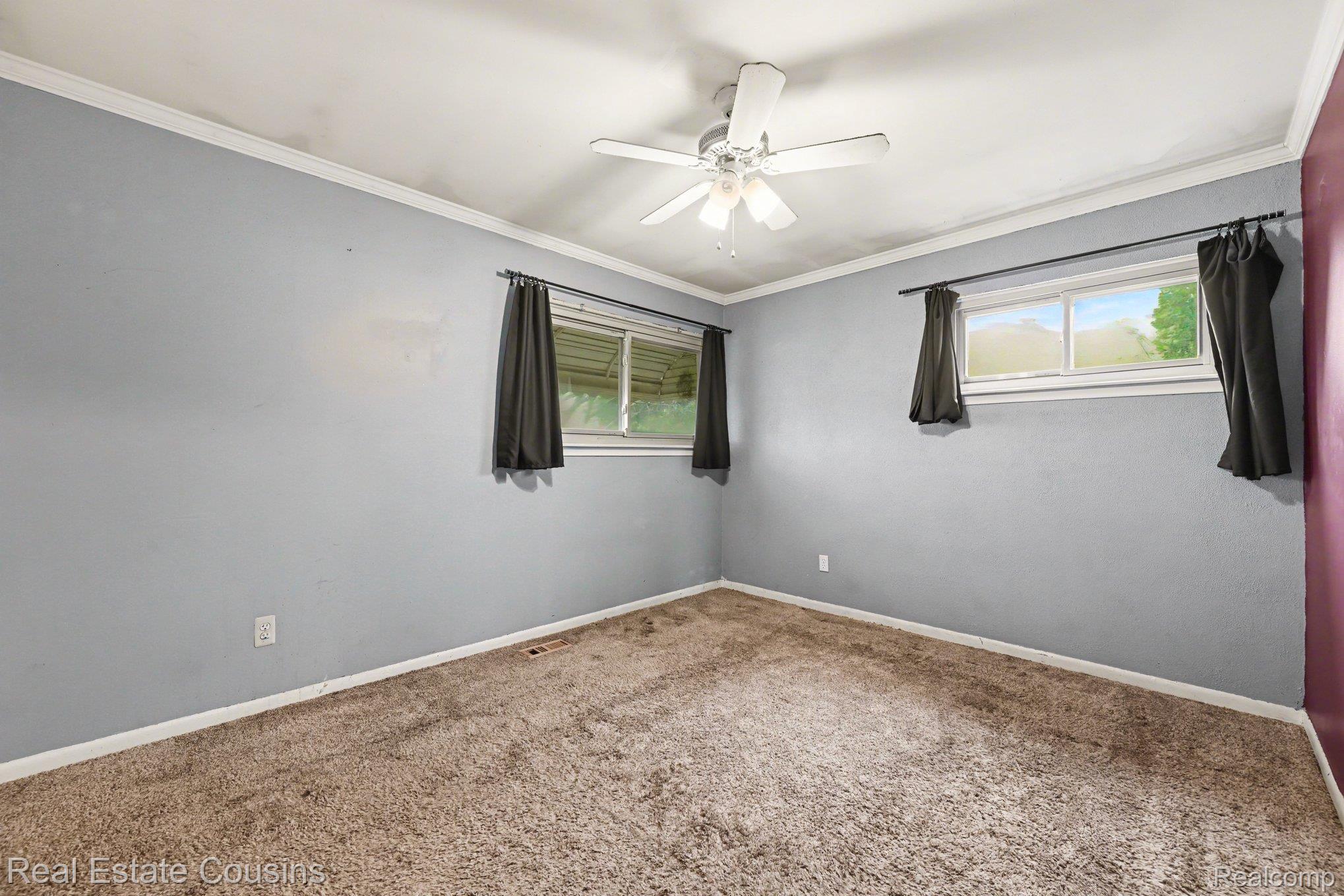 32224 Joy Road Livonia, MI 48150 - Photo 15 of 33 Empty room with carpet floors, crown molding, and ceiling fan