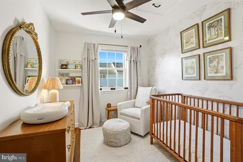 a bedroom with furniture and a large window