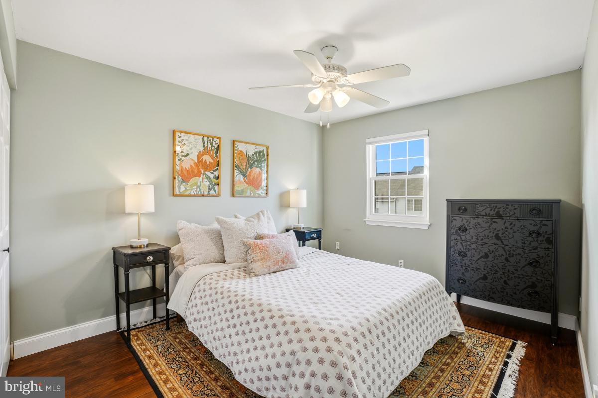 5712 Richardson Mews Square Halethorpe, MD 21227 - Photo 17 of 29 a bedroom with a bed and wooden floor