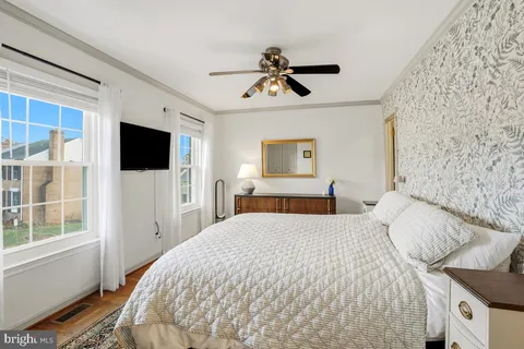 a bedroom with a large bed and a flat tv screen