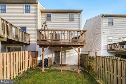 a view of a house with wooden fence