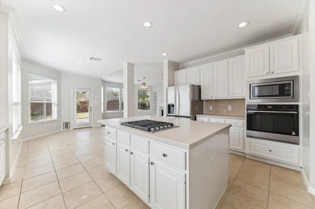 a kitchen with a stove a sink and a refrigerator