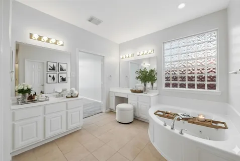 a white bath tub sitting next to a bathroom sink