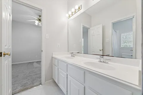 a bathroom with 2 sink and a mirror