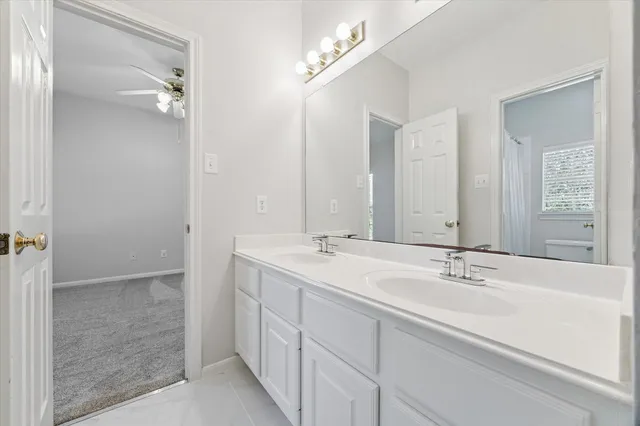 a bathroom with 2 sink and a mirror