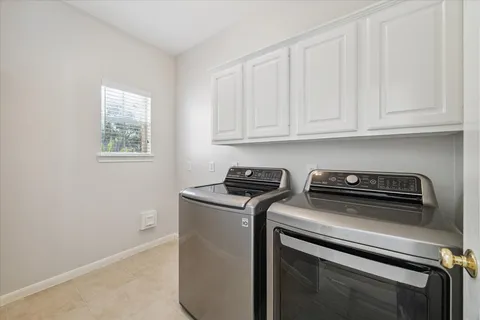a view of washer and dryer with kitchen countertops