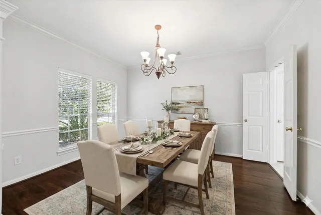 a view of a dining room with furniture a chandelier and wooden floor