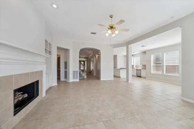 a view of an empty room with a fireplace and a window