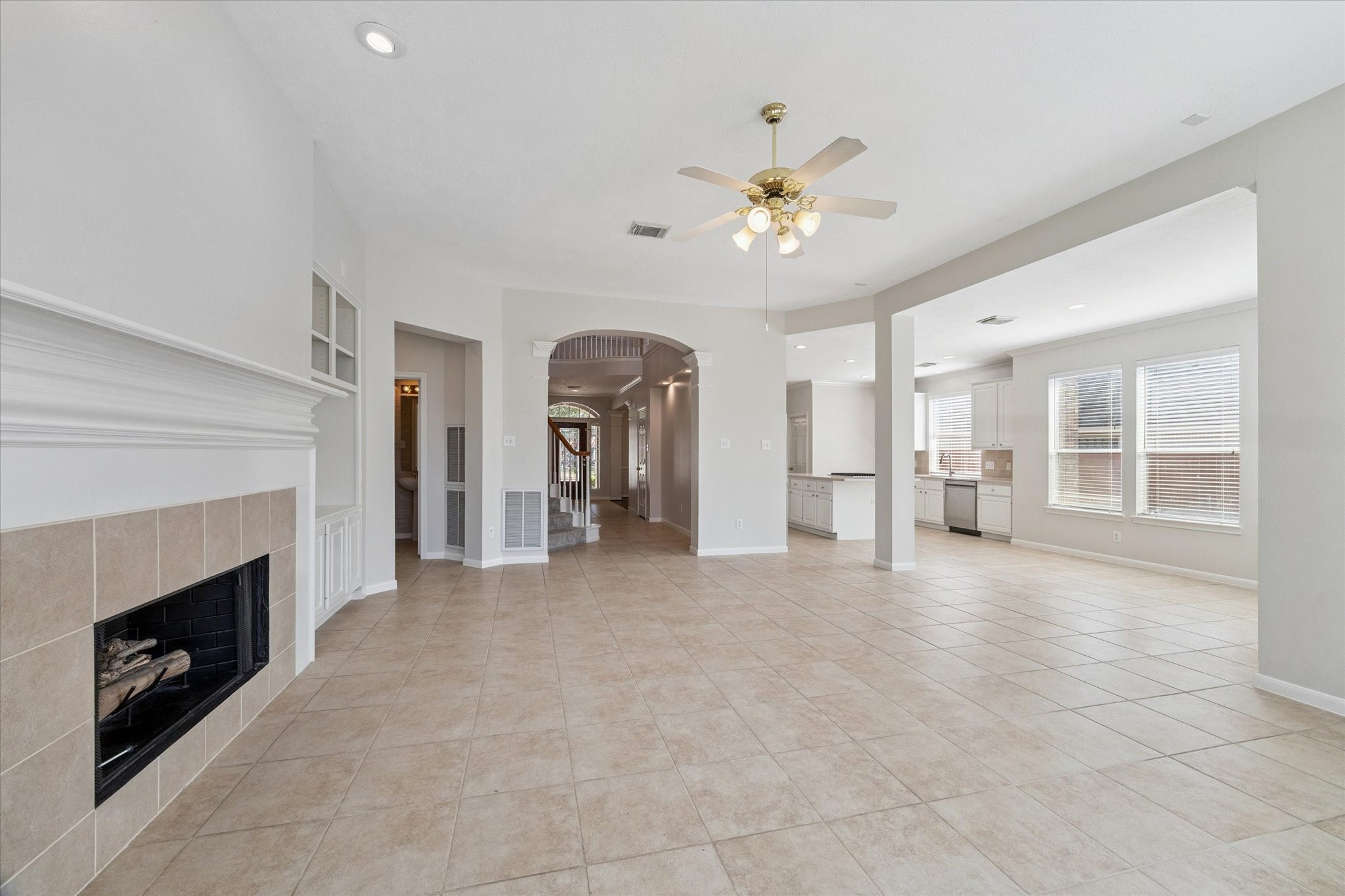 12019 Costa Del Rey Court Houston, TX 77041 - Photo 9 of 32 a view of an empty room with a fireplace and a window