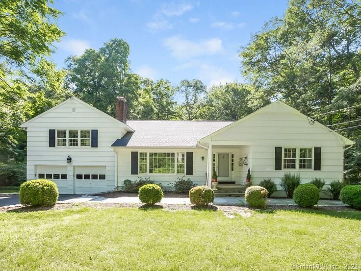 a view of a house with a yard outdoor seating and barbeque oven