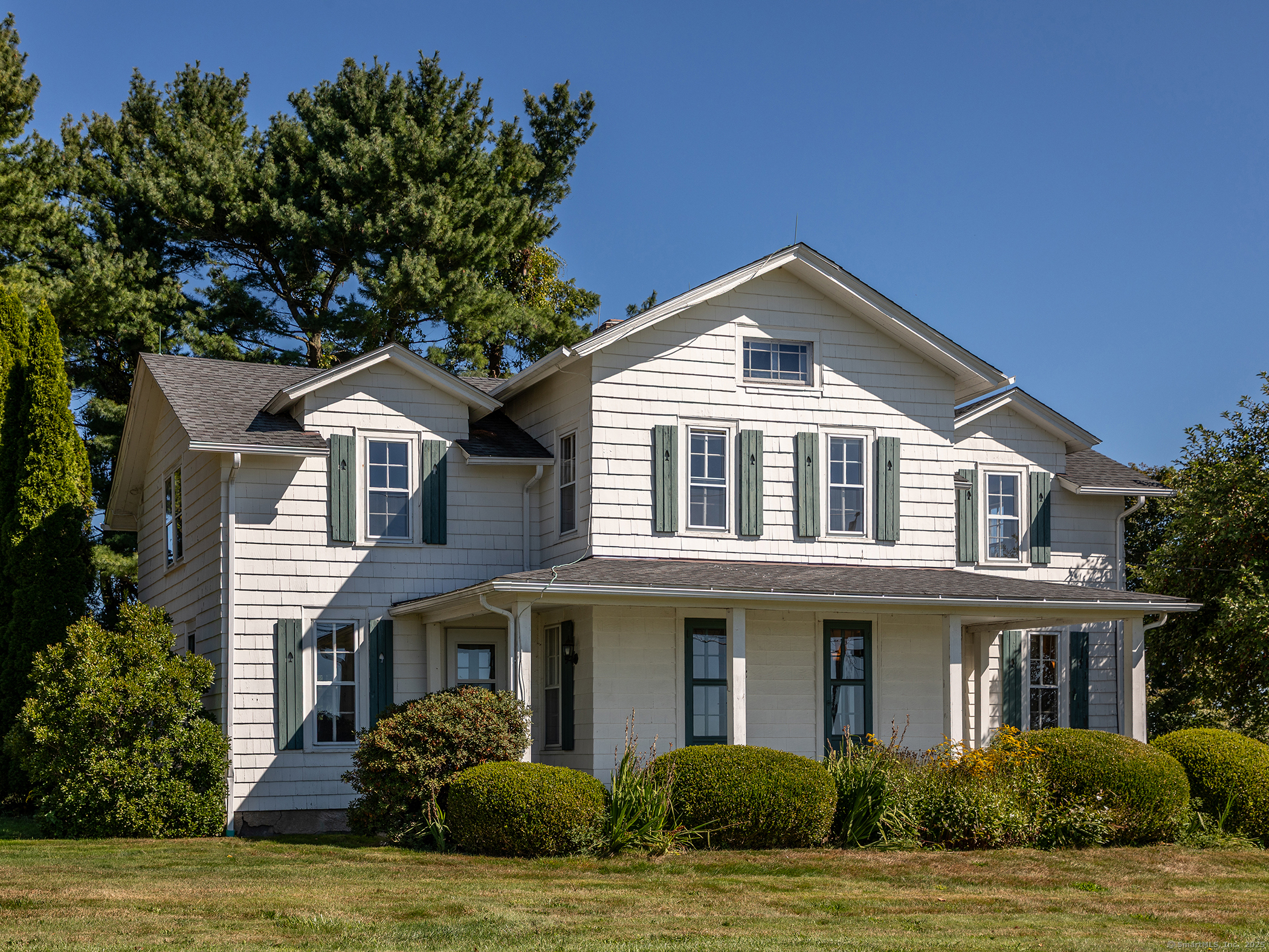 a front view of a house with a garden