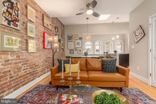 a living room with a couch and a chandelier