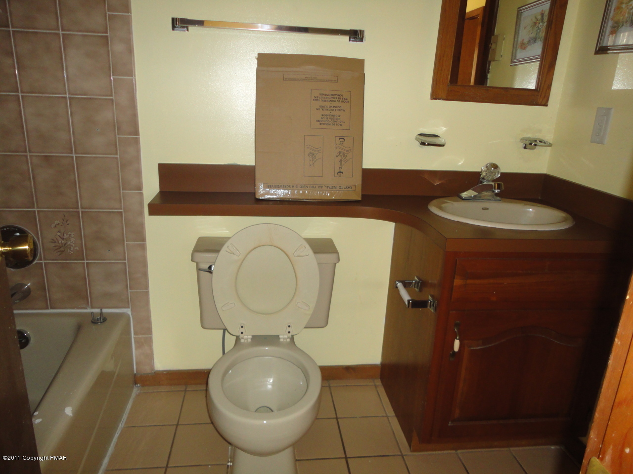 211 Decker Road Bushkill, PA 18324 - Photo 3 of 5 a bathroom with a granite countertop toilet a mirror and a sink