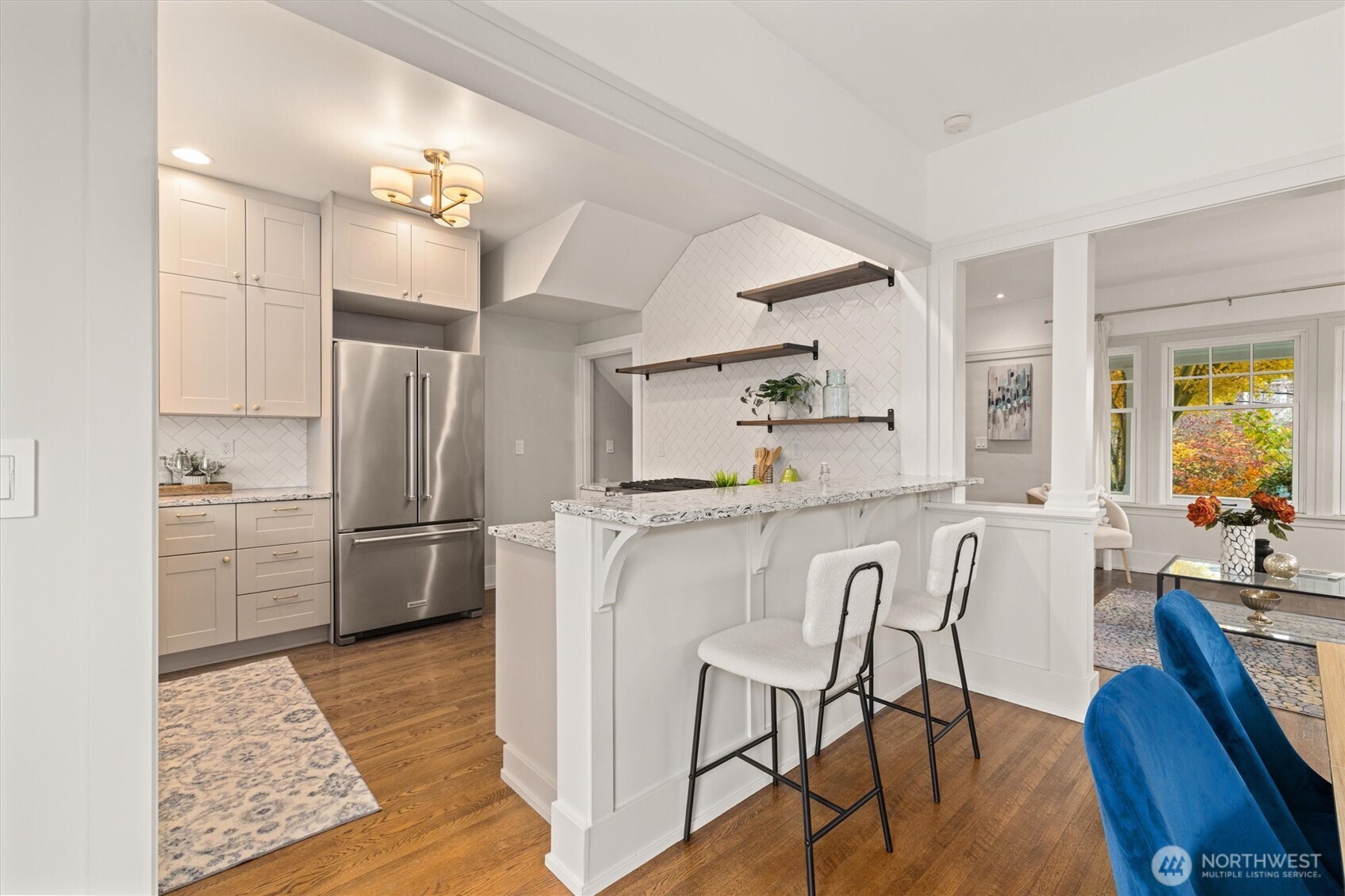 2912 3rd Avenue North Seattle, WA 98109 - Photo 13 of 37 a kitchen with white cabinets and stainless steel appliances