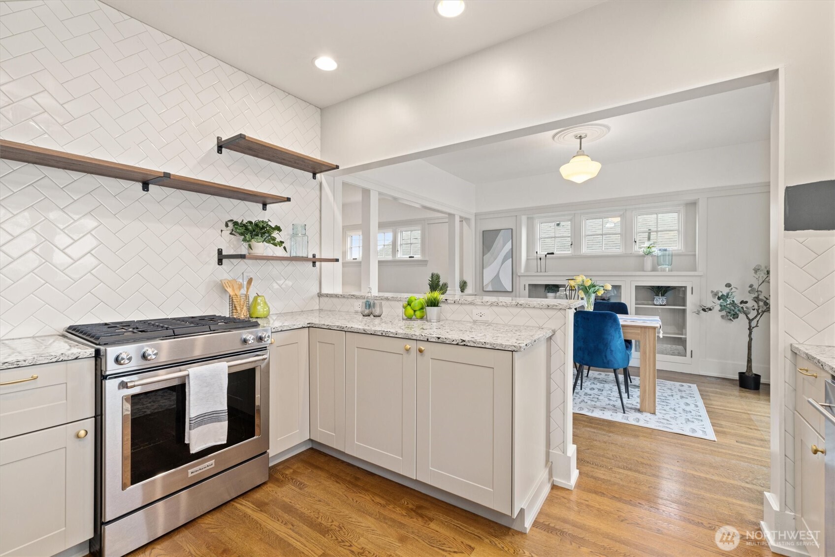 2912 3rd Avenue North Seattle, WA 98109 - Photo 14 of 37 a kitchen with a stove cabinets and wooden floor