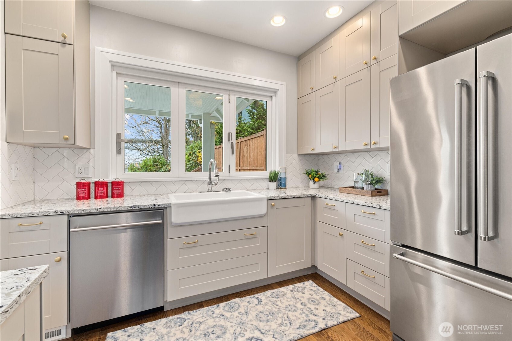 2912 3rd Avenue North Seattle, WA 98109 - Photo 16 of 37 a kitchen with white cabinets sink and refrigerator