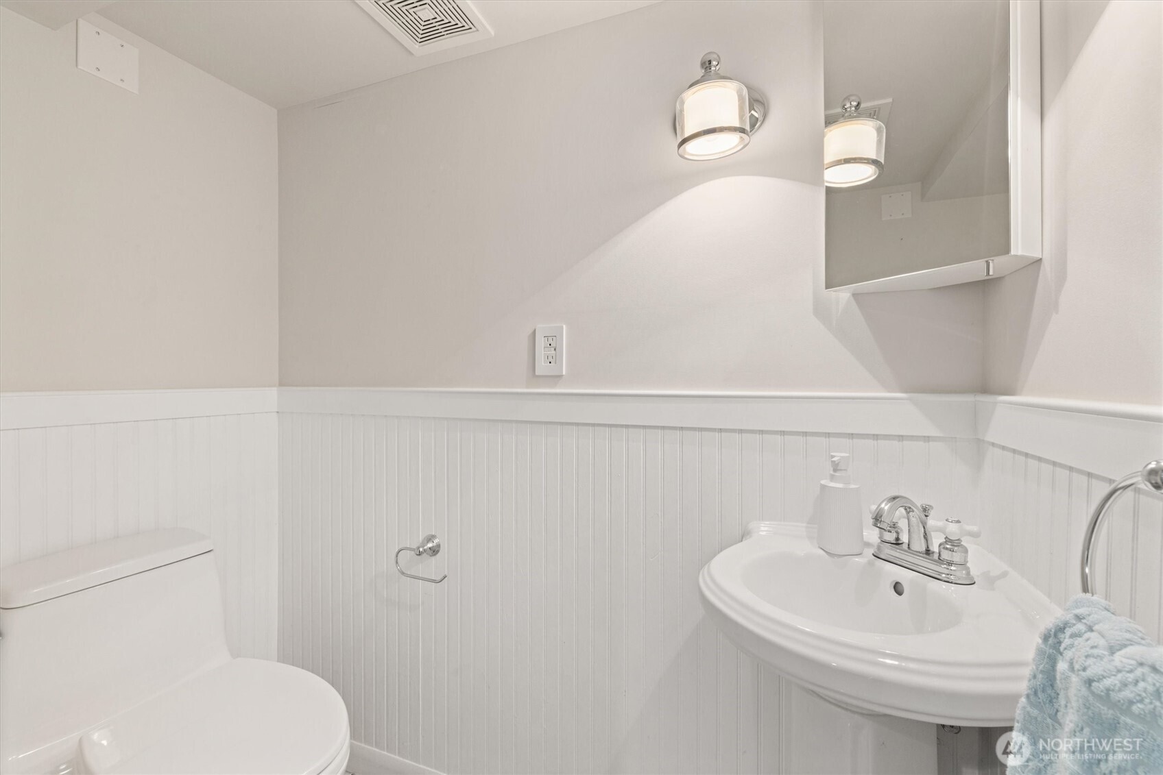2912 3rd Avenue North Seattle, WA 98109 - Photo 22 of 37 a bathroom with a sink a toilet and a mirror