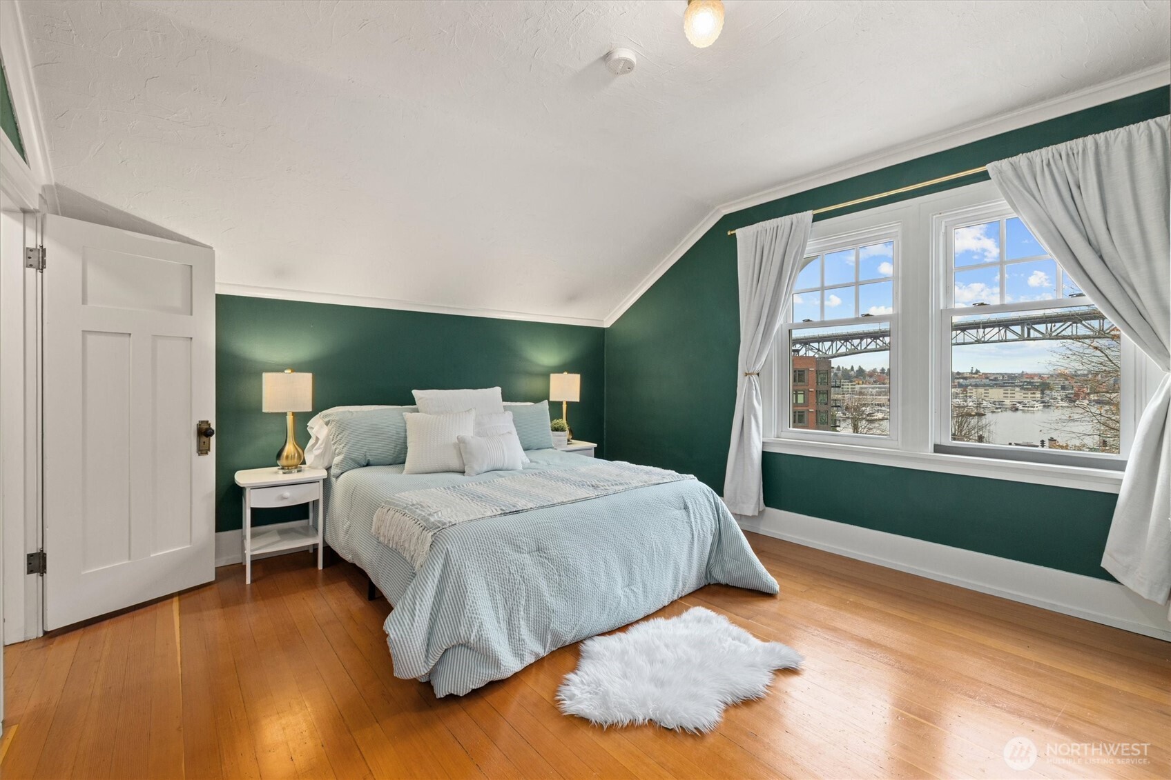 2912 3rd Avenue North Seattle, WA 98109 - Photo 24 of 37 a bedroom with a large bed and a large window