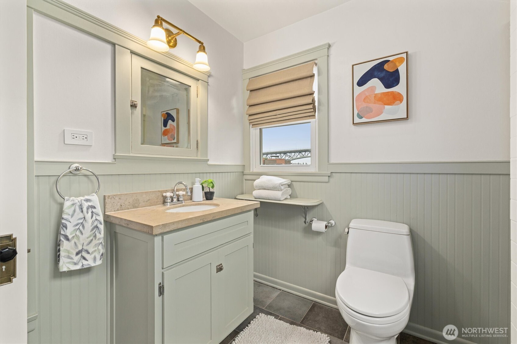 2912 3rd Avenue North Seattle, WA 98109 - Photo 27 of 37 a bathroom with a toilet a sink and mirror
