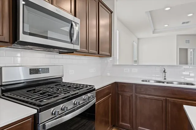 a stove top oven sitting inside of a kitchen