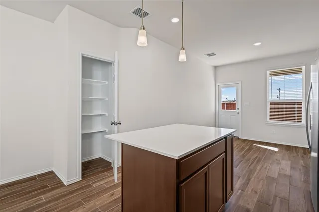 a room with a wooden floor and white walls