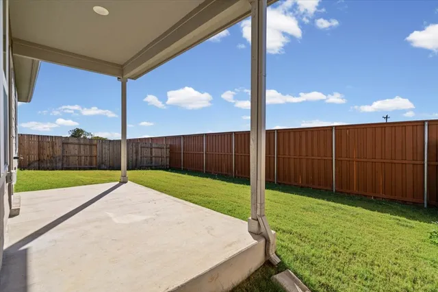 a view of a backyard with grass