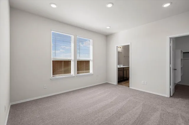 an empty room with a kitchen and a window