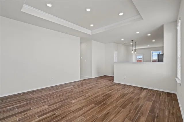 a view of a room with wooden floor and window