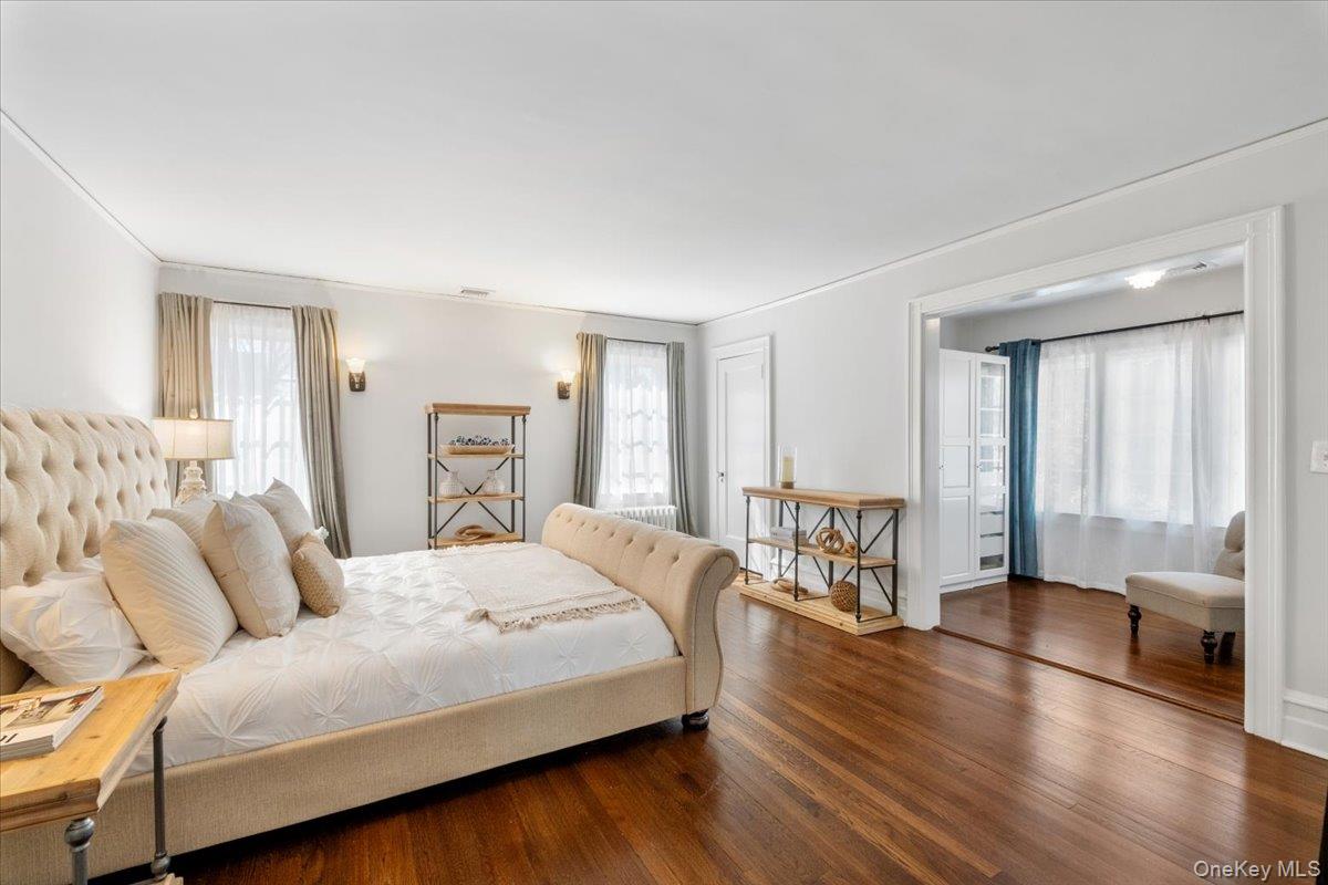 9 Lockwood Road Scarsdale, NY 10583 - Photo 13 of 33 a bedroom with a large bed and wooden floor