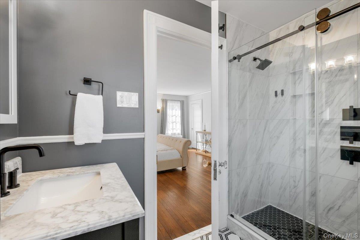 9 Lockwood Road Scarsdale, NY 10583 - Photo 14 of 33 a bathroom with a sink and a mirror