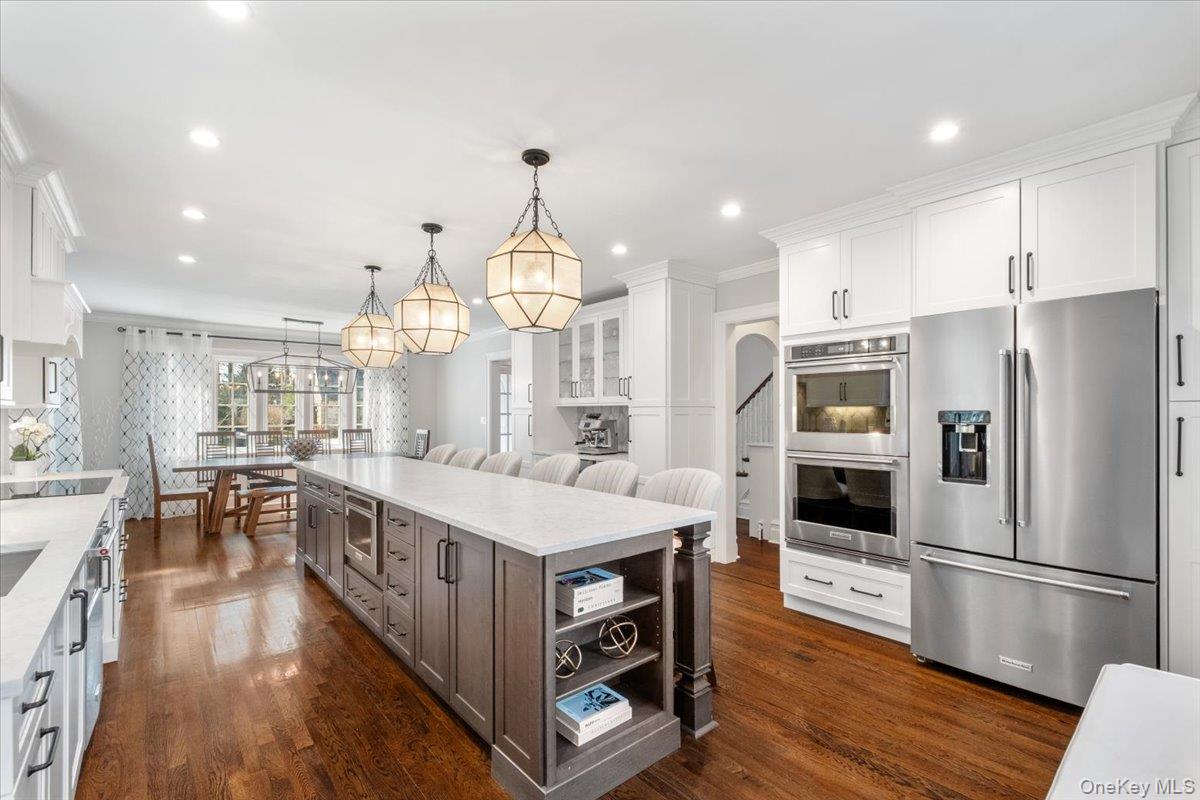 9 Lockwood Road Scarsdale, NY 10583 - Photo 2 of 33 a kitchen with counter top space stainless steel appliances and wooden floor