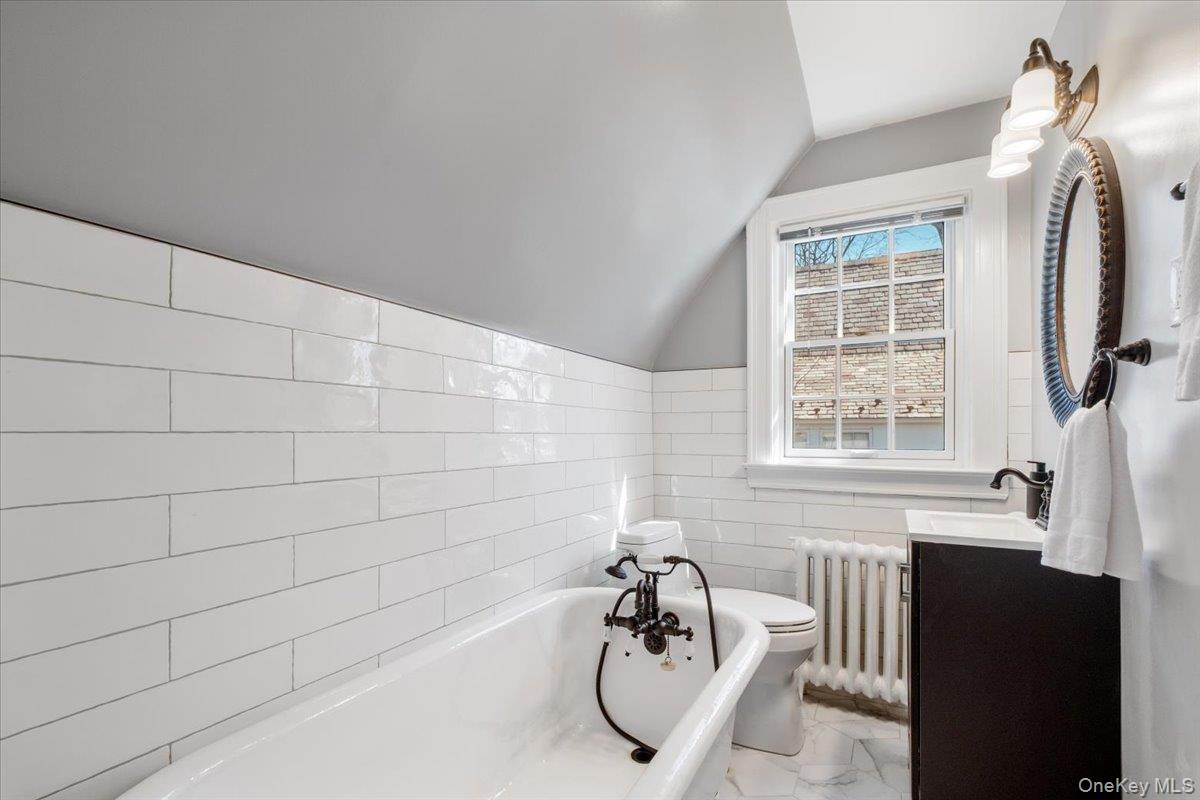 9 Lockwood Road Scarsdale, NY 10583 - Photo 21 of 33 a bathroom with a tub and a window