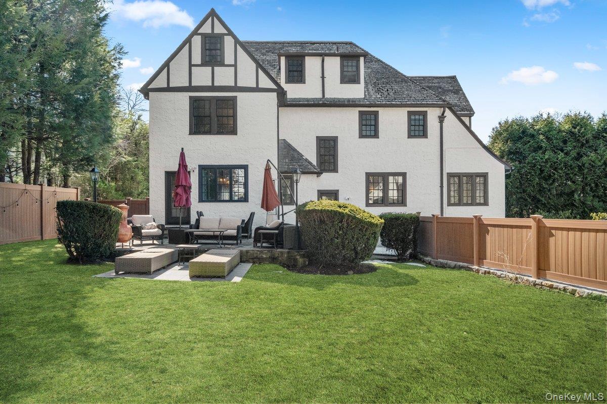 9 Lockwood Road Scarsdale, NY 10583 - Photo 25 of 33 a view of a house with backyard sitting area and garden