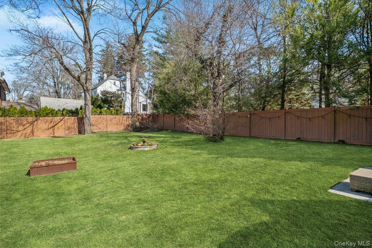 9 Lockwood Road Scarsdale, NY 10583 - Photo 27 of 33 a backyard of a house with lots of green space