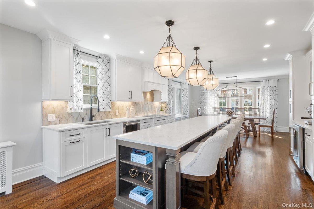 9 Lockwood Road Scarsdale, NY 10583 - Photo 4 of 33 a kitchen with stainless steel appliances granite countertop a kitchen island hardwood floor sink stove dining table and chairs