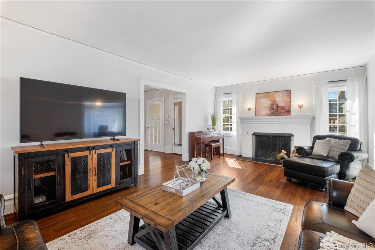 9 Lockwood Road Scarsdale, NY 10583 - Photo 6 of 33 a living room with furniture a flat screen tv and a fireplace