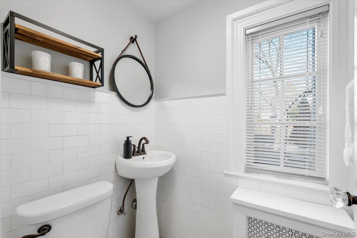 9 Lockwood Road Scarsdale, NY 10583 - Photo 10 of 33 a bathroom with a sink a toilet and a mirror