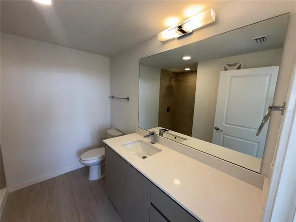 an empty room with wooden floor and closet