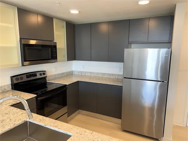 a kitchen with a refrigerator and a sink