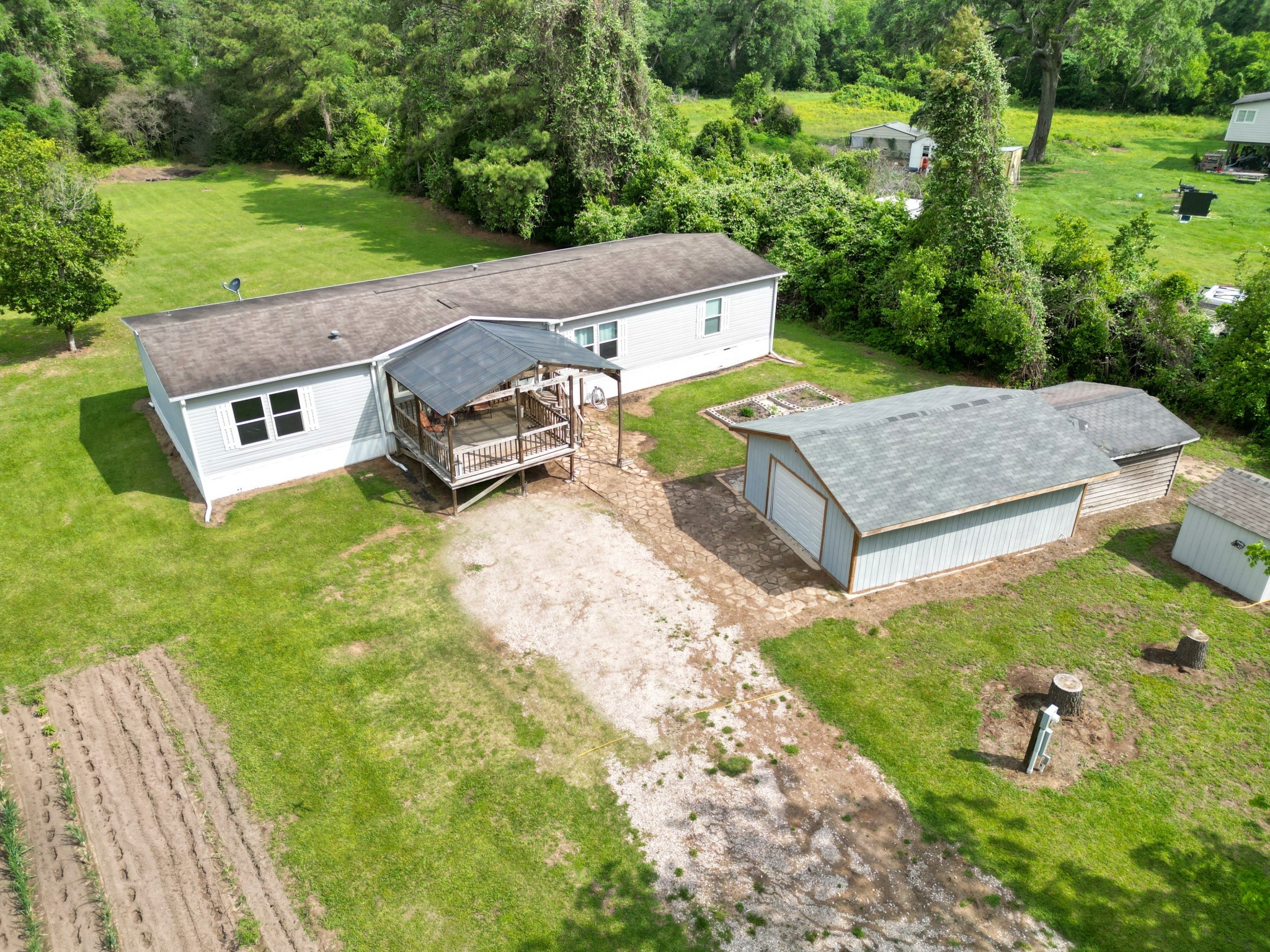 an aerial view of a house with garden space and street view