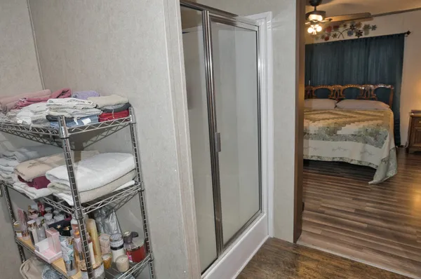 a bedroom with a bed and a mirror