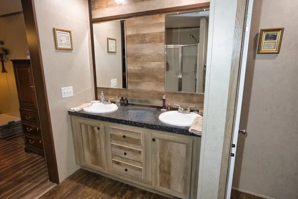 a bathroom with a granite countertop sink and mirror