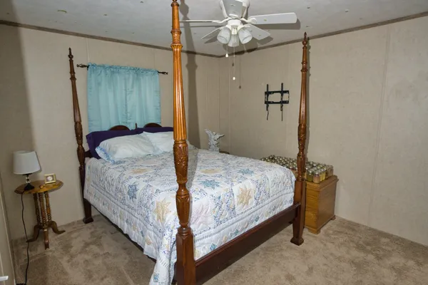 a bedroom with a bed and a chandelier