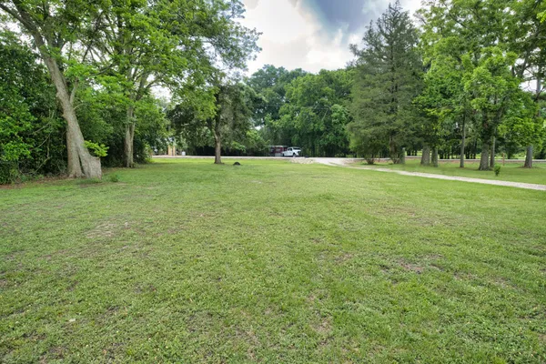 a view of field with trees in the background