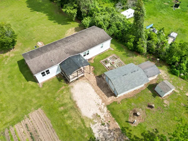 an aerial view of a house with a yard