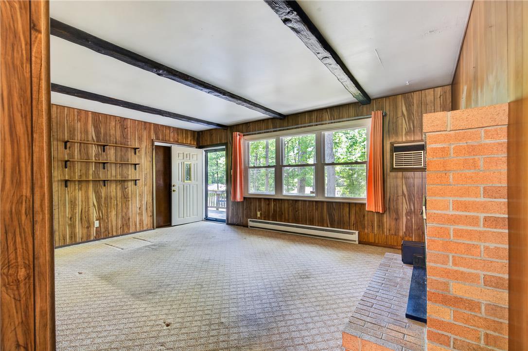 18 White Oak Road Nesquehoning, PA 18240 - Photo 12 of 52 A rustic interior with exposed wooden beams and a brick fireplace awaits your personal touch.