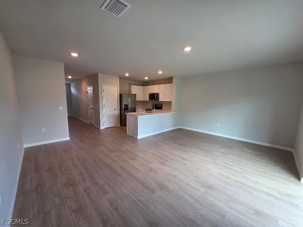 a view of a kitchen with a sink and a refrigerator