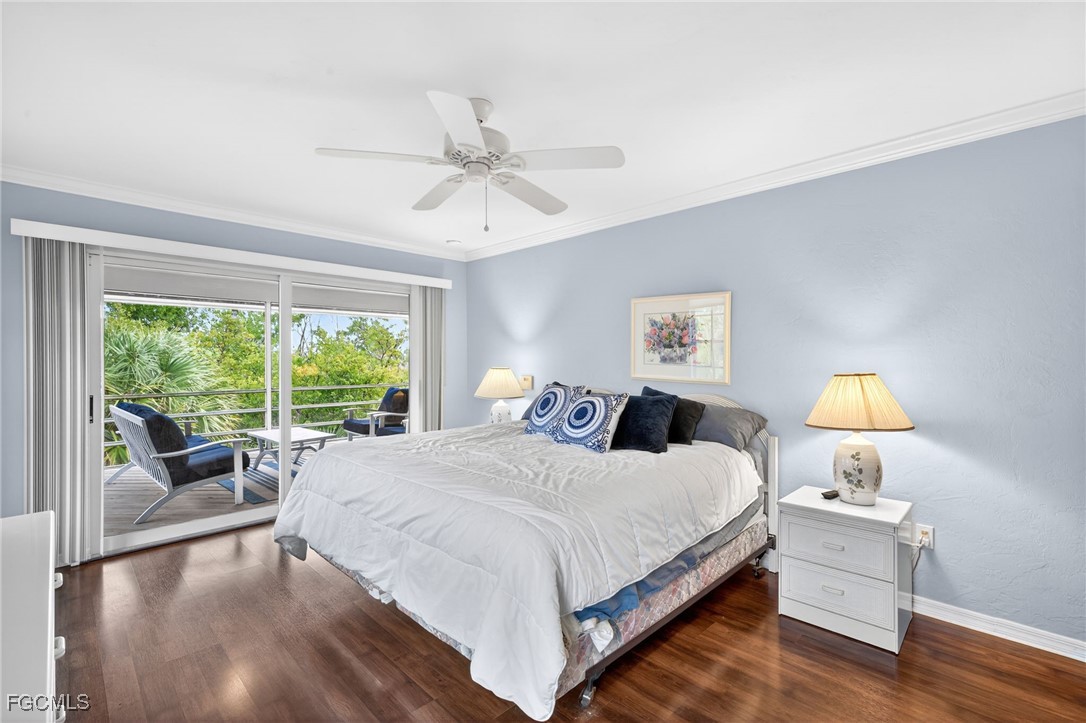 966 Sand Castle Road Sanibel, FL 33957 - Photo 15 of 39 a bedroom with a bed and a lamp on table