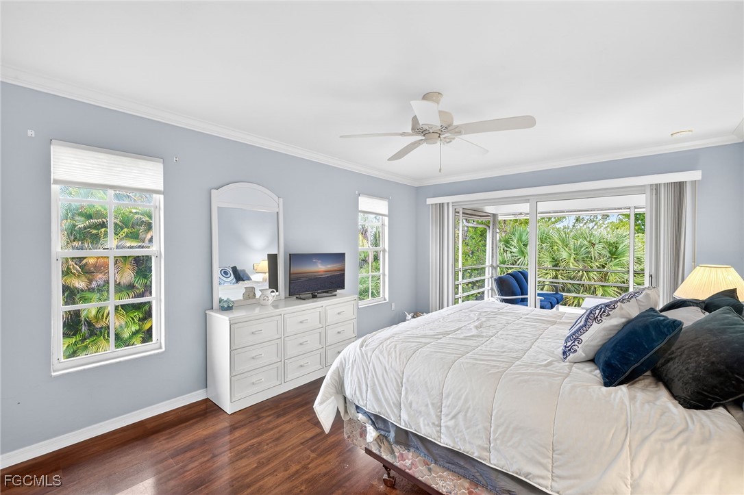 966 Sand Castle Road Sanibel, FL 33957 - Photo 17 of 39 a bedroom with a large bed and a flat tv screen