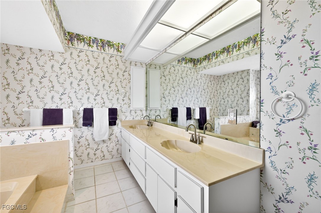 966 Sand Castle Road Sanibel, FL 33957 - Photo 18 of 39 a bathroom with a sink double vanity and a shower